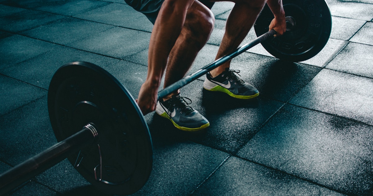 Person exercising in a gym, representing health measurements beyond BMI