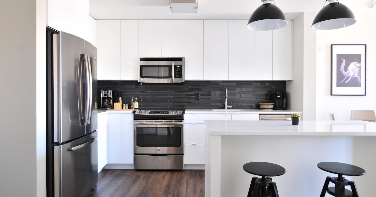 Modern kitchen with timber-look flooring laid in a straight pattern