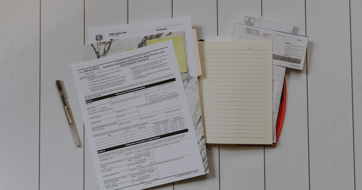 Australian tax paperwork, calculator and notebook on a desk