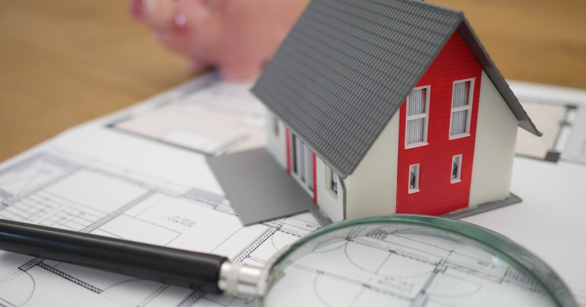 Mortgage documents, keys and calculator on a desk