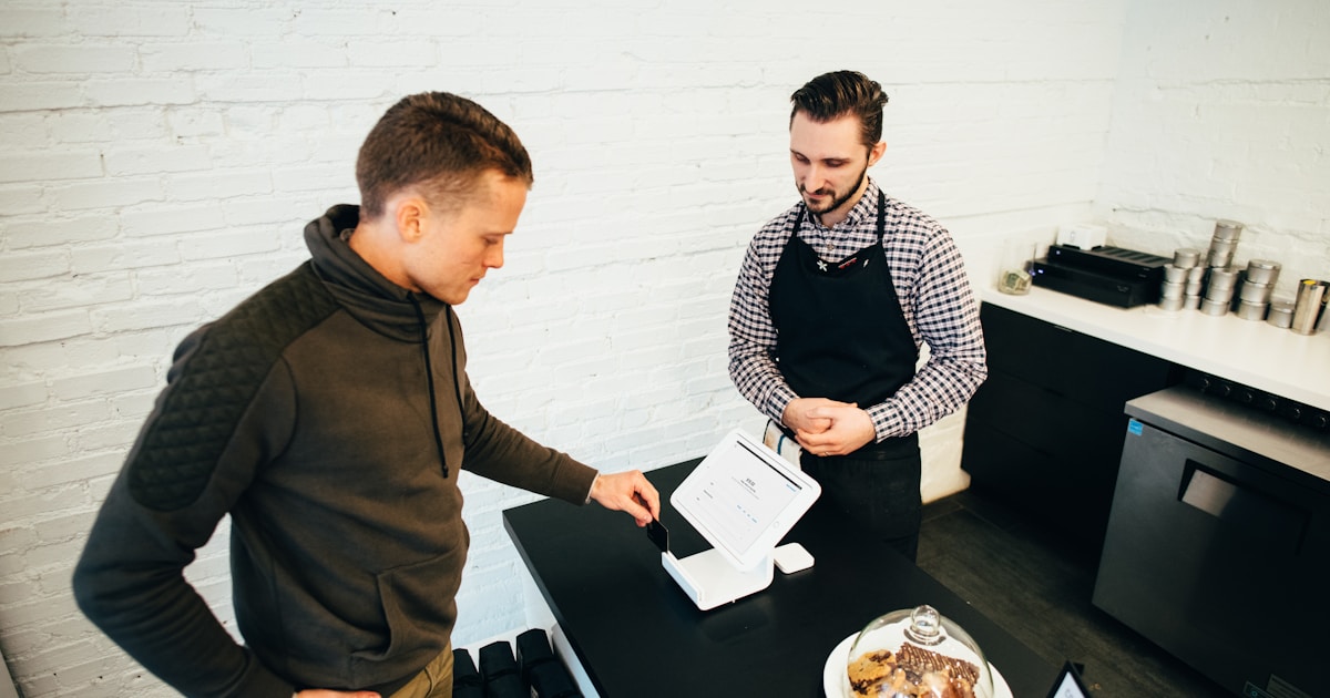 Customer paying for coffee at a cafe counter