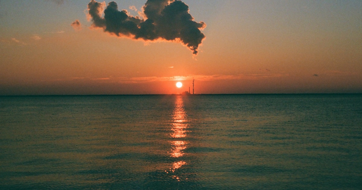 Calculator, notebook and budgeting paperwork on a desk