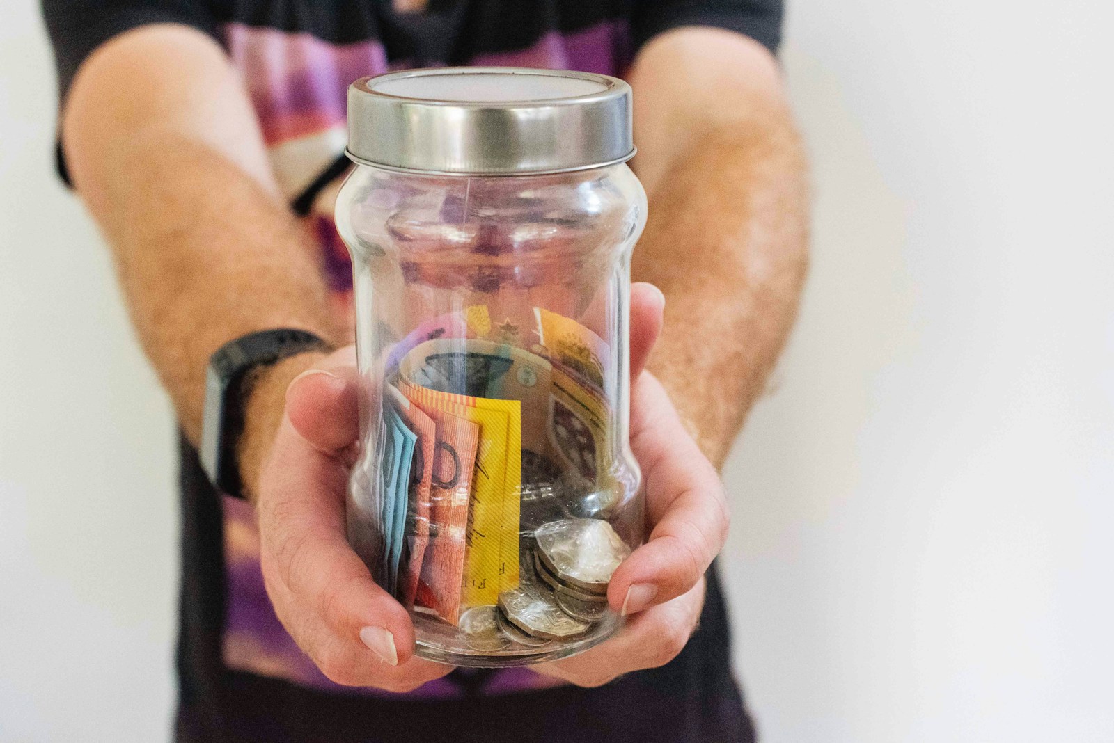 Australian money in a savings jar representing retirement income and superannuation